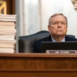 senator links fed chair vote doj probe