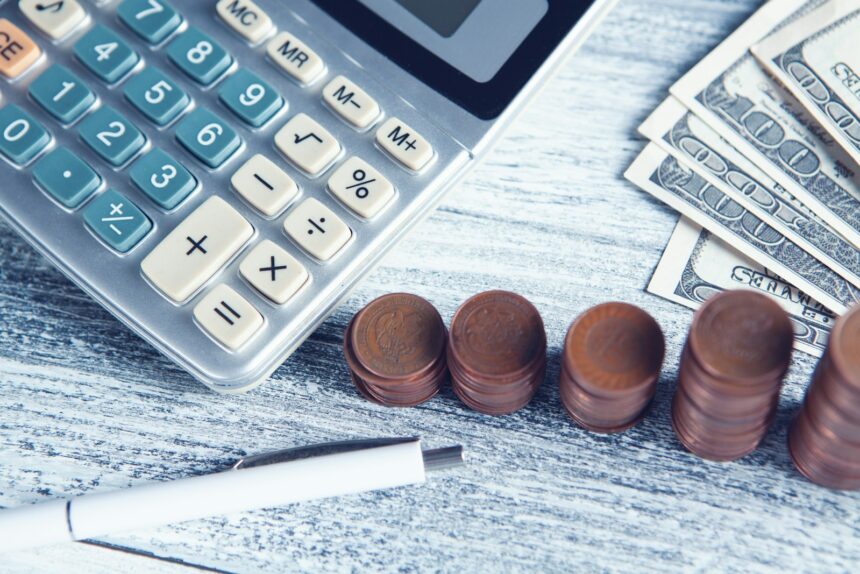 a calculator, pen, and money on a table; ERP integration