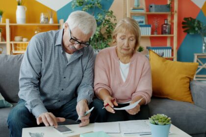 Elderly couple reviewing documents at home; social security trust fund 2032