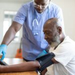 a doctor checking a patient's blood pressure; Medicare Part B premium 2027