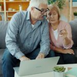 Elderly couple looking at a laptop together; annuity sales 2026
