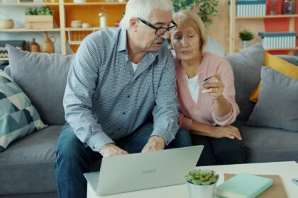 Elderly couple looking at a laptop together; annuity sales 2026