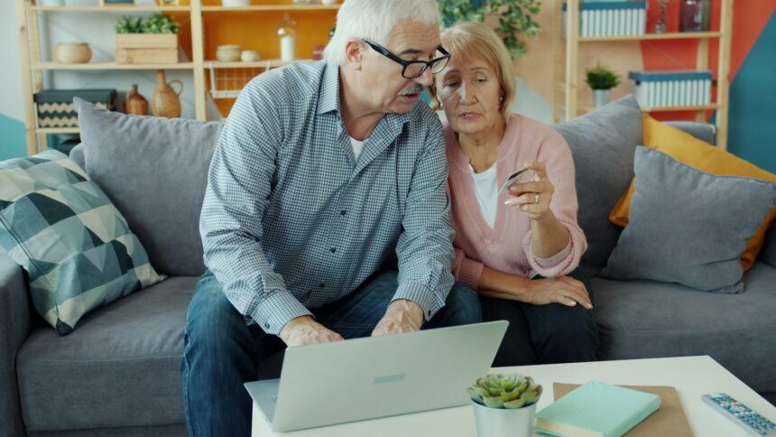 Elderly couple looking at a laptop together; annuity sales 2026