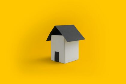 a white house with a black roof on a yellow background; senior home equity